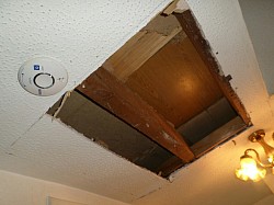 Ceiling hole undergoing reboard after young lad living there jumped through floor
