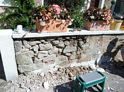 Old cottage garden wall chipping out ready for repoint in lime