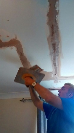 Starting ceiling patching after shower pipework repair from below
