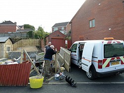Storm damage, digging in new fenceposts and reducing fence height with nephew
