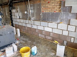 Rebuilding damaged wall in progress industrial warehouse