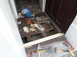 Repairs underway to elderly gentlemans entrance floor, repair wood and seal threshold, customer teaches table tennis at 93 years old